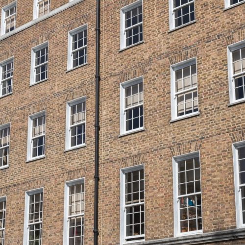 Facade,Of,A,Brick,Building,With,A,Symmetrical,Arrangement,Of